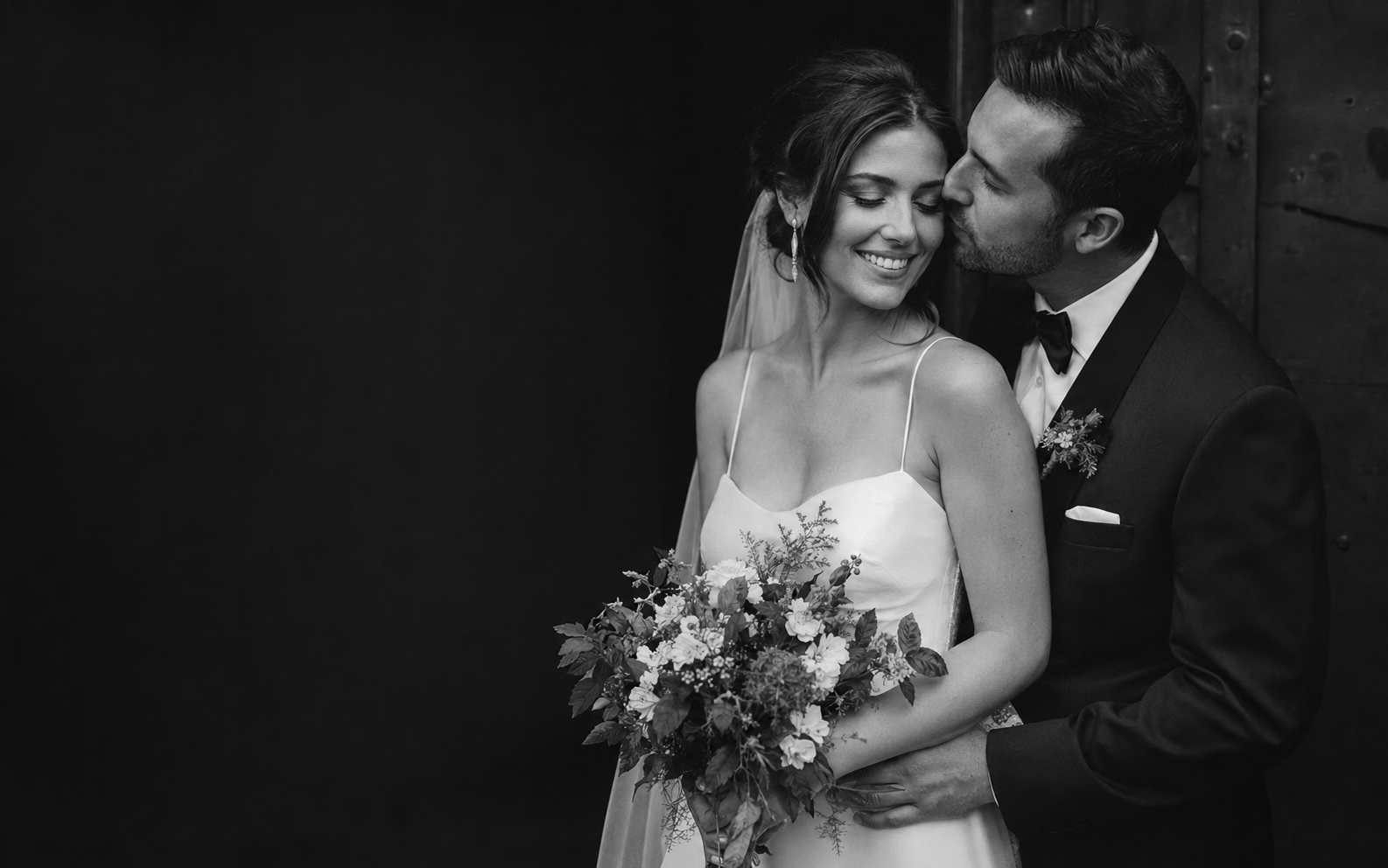 A joyful newlywed couple in an intimate editorial portrait